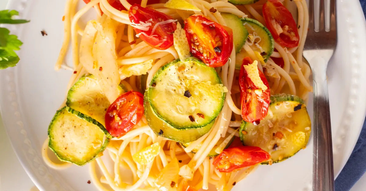 Vibrant pasta with zucchini noodles, cherry tomatoes, and fresh herbs