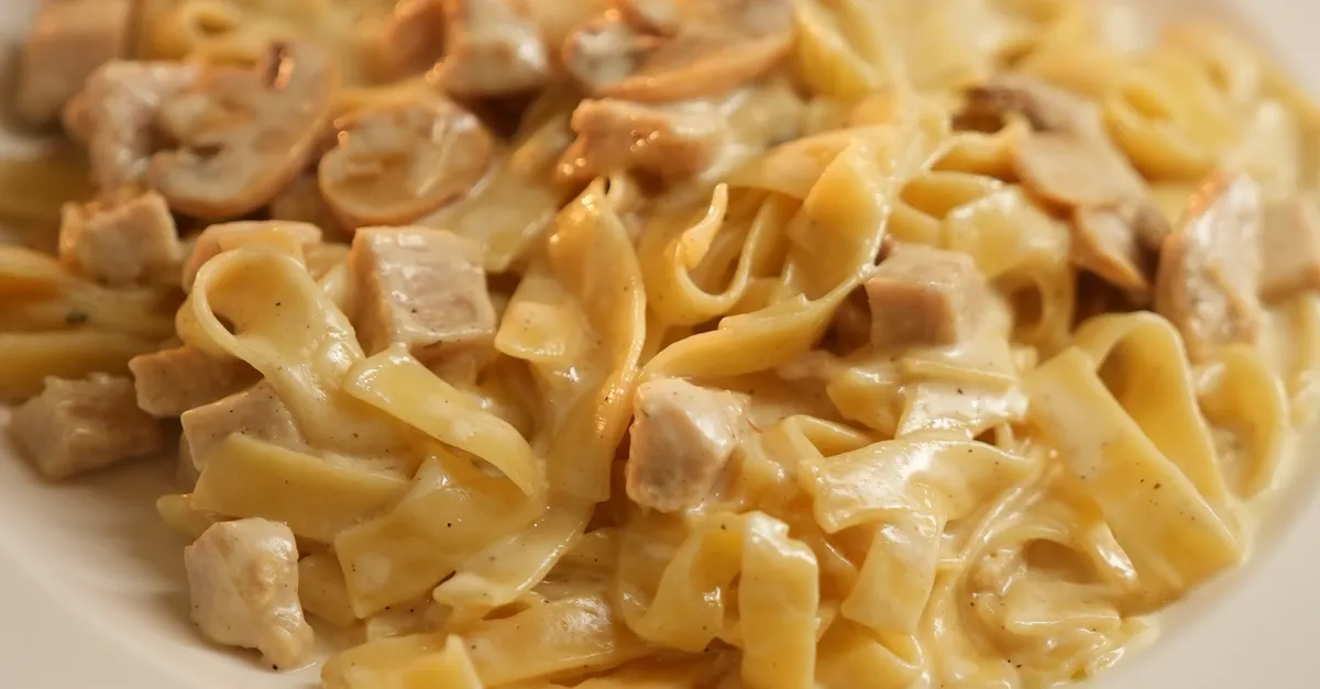 Creamy chicken alfredo fettuccine with mushrooms in a rich parmesan sauce