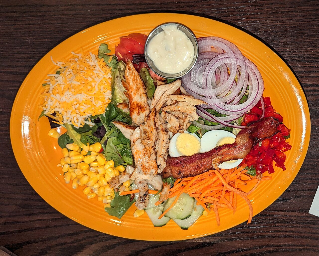 Classic cobb salad with rows of colorful toppings